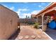Backyard features covered patio, landscaping, and partially shaded gravel area at 4565 Halbert Ave, Las Vegas, NV 89110