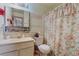 Cozy bathroom with vanity, floral shower curtain, and decorative accents at 4565 Halbert Ave, Las Vegas, NV 89110