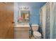 A blue-walled bathroom featuring a single sink vanity and patterned shower curtain at 4565 Halbert Ave, Las Vegas, NV 89110