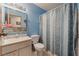 Blue bathroom features a single sink vanity and patterned shower curtain at 4565 Halbert Ave, Las Vegas, NV 89110