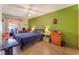 Comfortable bedroom with neutral walls, tile floors, ceiling fan, and natural light at 4565 Halbert Ave, Las Vegas, NV 89110