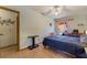 Comfortable bedroom with neutral walls, tile floors, ceiling fan, and closet access at 4565 Halbert Ave, Las Vegas, NV 89110
