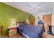 Comfortable bedroom with neutral walls, tile floors, ceiling fan, and ensuite bath at 4565 Halbert Ave, Las Vegas, NV 89110