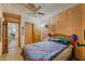 Wood paneled bedroom features a bed, ceiling fan, and closet with sliding doors at 4565 Halbert Ave, Las Vegas, NV 89110