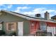 View of home exterior highlighting the roof-mounted solar panels and painted brick facade at 4565 Halbert Ave, Las Vegas, NV 89110