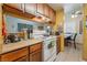 Cozy kitchen featuring wood cabinets, tile flooring, and an open layout at 4565 Halbert Ave, Las Vegas, NV 89110