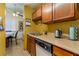 Cozy kitchen featuring wood cabinets, tile flooring, and stainless steel sink at 4565 Halbert Ave, Las Vegas, NV 89110