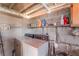 Indoor laundry room featuring washer, dryer, and cinder block wall with shelving at 4565 Halbert Ave, Las Vegas, NV 89110