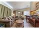 Comfortable living room with couch, piano, and view of the dining area at 4565 Halbert Ave, Las Vegas, NV 89110