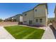 A backyard with artificial turf, brick-paved patio, and a sliding glass door on the house at 4633 Fragrant St, North Las Vegas, NV 89031
