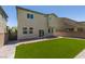 A house featuring artificial turf, brick-paved patio, and a sliding glass door at 4633 Fragrant St, North Las Vegas, NV 89031