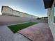 Spacious backyard with brick patio and artificial turf, perfect for entertaining or relaxing outdoors at 4633 Fragrant St, North Las Vegas, NV 89031