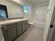 Bathroom featuring a double sink vanity and tile flooring, complemented by a shower-tub combination at 4633 Fragrant St, North Las Vegas, NV 89031