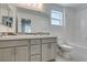 Bathroom featuring double sinks, modern vanity, shower with tub, mosaic tile, and a bright window at 4633 Fragrant St, North Las Vegas, NV 89031