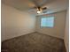 Neutral walls, plush carpet, and a ceiling fan define this cozy bedroom at 4633 Fragrant St, North Las Vegas, NV 89031