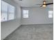 Bedroom with large windows, carpet flooring and a ceiling fan at 4633 Fragrant St, North Las Vegas, NV 89031