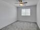 This bedroom features a modern ceiling fan, plush carpet, and a bright window, offering a cozy retreat at 4633 Fragrant St, North Las Vegas, NV 89031