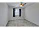 Bright bedroom with a ceiling fan, carpet flooring, a window and neutral-colored walls providing a blank canvas at 4633 Fragrant St, North Las Vegas, NV 89031