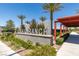 Entrance to Craig Ranch community features a modern sign, palm trees, and a covered walkway at 4633 Fragrant St, North Las Vegas, NV 89031
