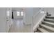 Bright foyer featuring wood-look tile floors, white trim, and a staircase leading to the upper level at 4633 Fragrant St, North Las Vegas, NV 89031