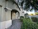 Covered entrance with decorative pillars, arched doorway, and lush landscaping creating a welcoming ambiance at 4633 Fragrant St, North Las Vegas, NV 89031