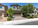 Inviting two-story home features a well-maintained front yard and a brick-paved driveway leading to a two-car garage at 4633 Fragrant St, North Las Vegas, NV 89031