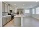 Modern kitchen with stainless steel appliances, an island, and gray cabinets at 4633 Fragrant St, North Las Vegas, NV 89031