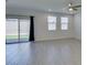 Bright living room with tile floors, sliding glass door to the backyard and a ceiling fan at 4633 Fragrant St, North Las Vegas, NV 89031