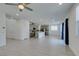 Open concept floor plan between kitchen and living room with sleek tile floors and recessed lighting at 4633 Fragrant St, North Las Vegas, NV 89031