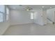 Spacious living area with tile floors, large windows, recessed lights and adjacent staircase at 4633 Fragrant St, North Las Vegas, NV 89031
