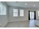 Bright living room with tile floors, multiple windows, and sliding glass door to the backyard at 4633 Fragrant St, North Las Vegas, NV 89031