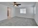 Bright main bedroom with ensuite bathroom, carpet flooring, ceiling fan and windows at 4633 Fragrant St, North Las Vegas, NV 89031