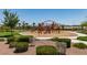 Community playground features colorful play structures, mature trees, and well maintained landscaping at 4633 Fragrant St, North Las Vegas, NV 89031