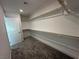 Large walk-in closet with carpeted floors and ample storage shelves at 4633 Fragrant St, North Las Vegas, NV 89031