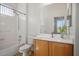 Bright bathroom featuring a shower-tub combination, light wood vanity, and an elegant decorative mirror at 5017 Kaibab Forest Ave, Las Vegas, NV 89141