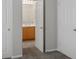 View into bright bathroom with a light wood vanity, ceramic tile floor and white doors at 5017 Kaibab Forest Ave, Las Vegas, NV 89141