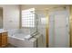 Bathroom showcases a soaking tub with a glass block window and a separate glass-enclosed shower at 5017 Kaibab Forest Ave, Las Vegas, NV 89141