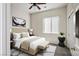 This staged bedroom boasts ample lighting, a queen-size bed, and a stylish neutral palette at 5017 Kaibab Forest Ave, Las Vegas, NV 89141