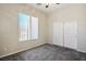 Unfurnished bedroom with carpet, featuring a sliding door closet and natural light at 5017 Kaibab Forest Ave, Las Vegas, NV 89141