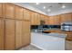 Spacious kitchen featuring wood cabinets, granite countertops, and stainless steel appliances at 5017 Kaibab Forest Ave, Las Vegas, NV 89141