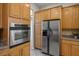 View of a kitchen featuring oak cabinets, stainless steel appliances, and granite countertops at 5017 Kaibab Forest Ave, Las Vegas, NV 89141