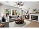 Staged living room featuring a cozy fireplace, a large window, and stylish decor for a welcoming atmosphere at 5017 Kaibab Forest Ave, Las Vegas, NV 89141