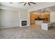 Open-concept living space with a fireplace, lots of cabinetry, and tile flooring with a connecting kitchen at 5017 Kaibab Forest Ave, Las Vegas, NV 89141