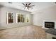 Bright and airy living room features a fireplace, large windows, and neutral tile flooring at 5017 Kaibab Forest Ave, Las Vegas, NV 89141