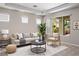Bright living room with neutral tones, stylish furniture, and a sliding glass door to the patio at 5017 Kaibab Forest Ave, Las Vegas, NV 89141