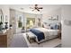 Staged main bedroom featuring neutral colors, a bay window, and ample natural light at 5017 Kaibab Forest Ave, Las Vegas, NV 89141