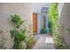 Exterior shot of a quaint stone walkway leading to the front entrance surrounded by lush, mature landscaping at 5017 Kaibab Forest Ave, Las Vegas, NV 89141