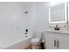Bathroom featuring a shower and tub combination, toilet, and vanity with a lighted mirror at 502 Edgefield Ridge Pl, Henderson, NV 89012