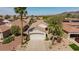 Charming single-story home featuring a well-maintained lawn, a spacious driveway, and mature palm trees at 502 Edgefield Ridge Pl, Henderson, NV 89012