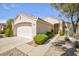 Charming single-story home featuring desert landscaping, a two-car garage, and a covered entryway at 502 Edgefield Ridge Pl, Henderson, NV 89012